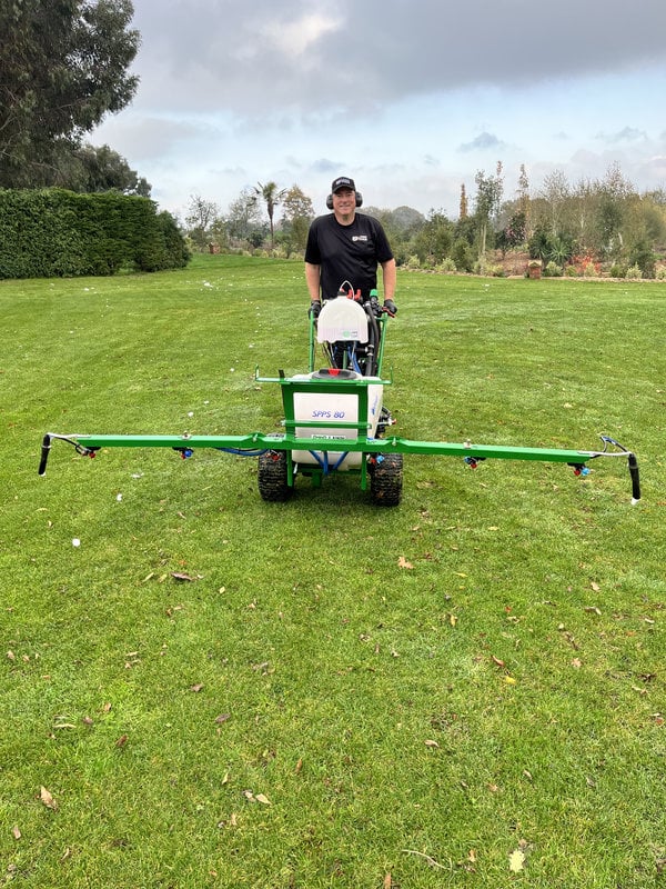 Spraying a large lawn with a boom sprayer