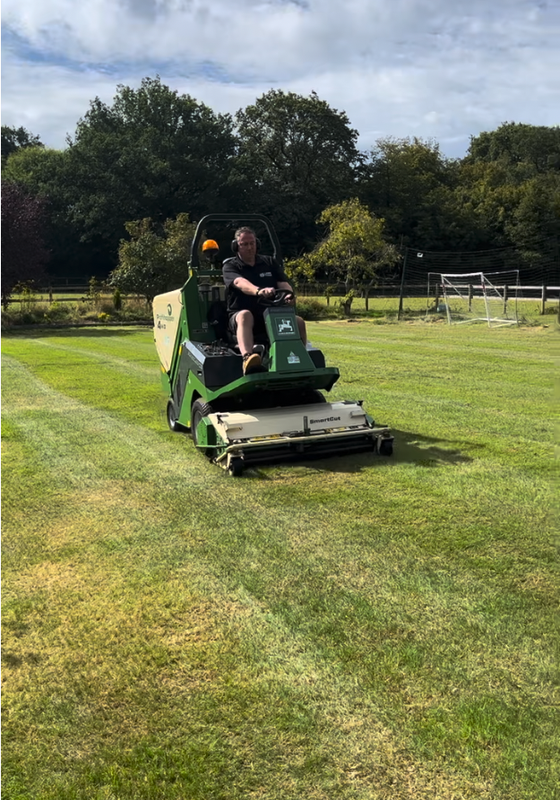 ride on scarifier being used to renovate a large lawn 